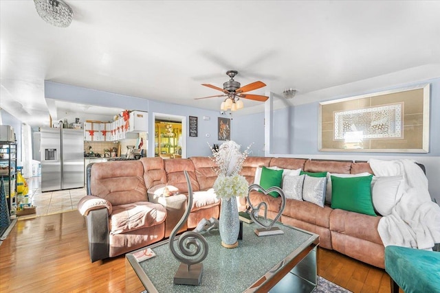 living room featuring ceiling fan and light wood-type flooring