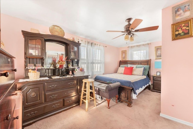 bedroom featuring light carpet and ceiling fan