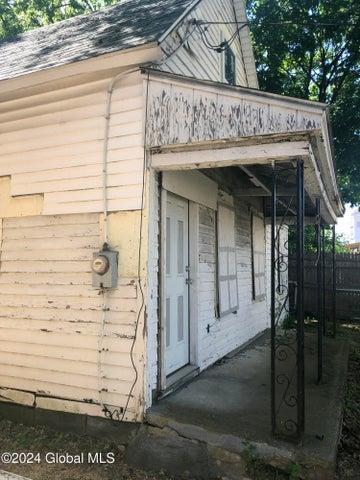 view of outbuilding featuring fence