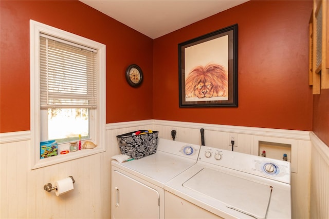 clothes washing area with separate washer and dryer