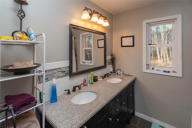 bathroom with tile patterned floors, vanity, and tasteful backsplash