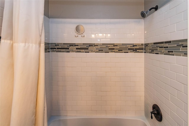 bathroom with shower / bath combo with shower curtain