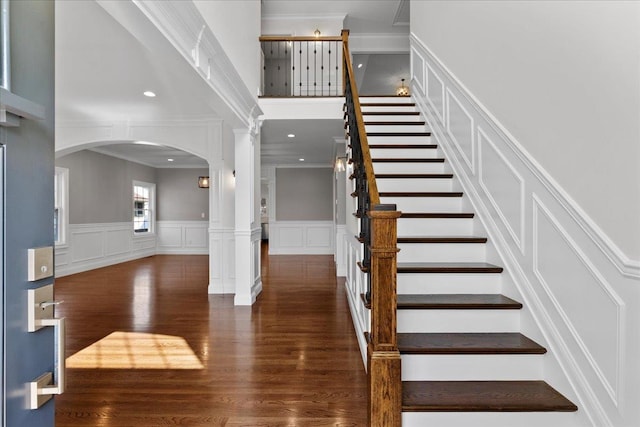 entryway with ornate columns, crown molding, and dark hardwood / wood-style flooring