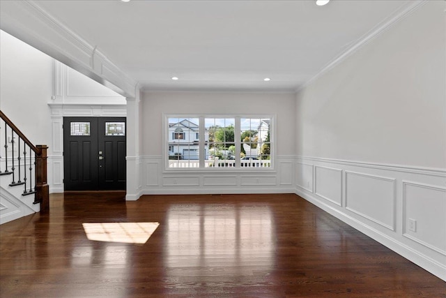 entrance foyer with dark hardwood / wood-style floors and crown molding