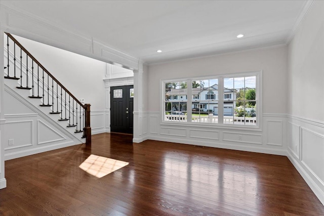 foyer entrance with crown molding and hardwood / wood-style flooring