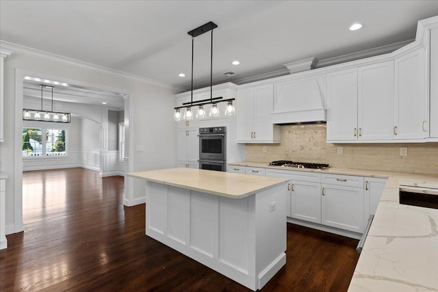 kitchen with premium range hood, stainless steel appliances, dark wood-type flooring, white cabinets, and a kitchen island