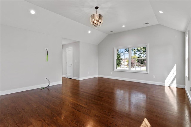 unfurnished living room with dark hardwood / wood-style flooring, a chandelier, and vaulted ceiling