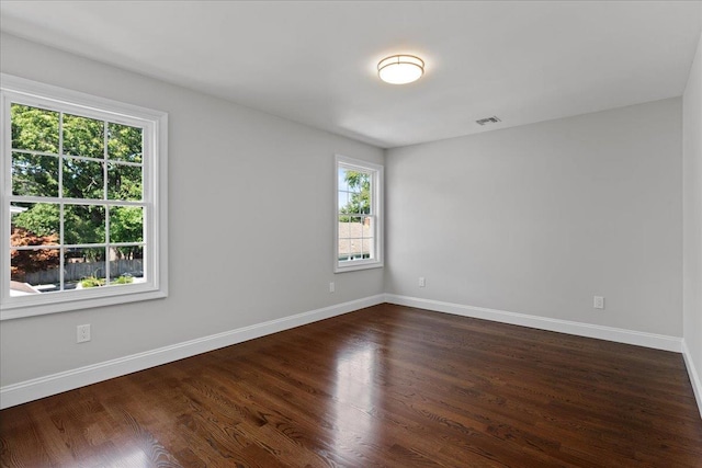 empty room with dark wood-type flooring