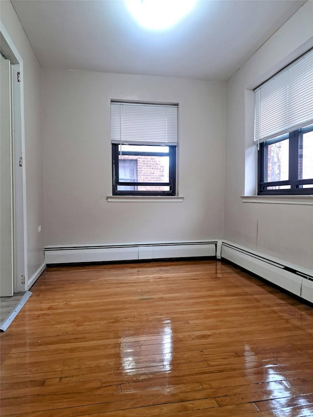 empty room with hardwood / wood-style flooring