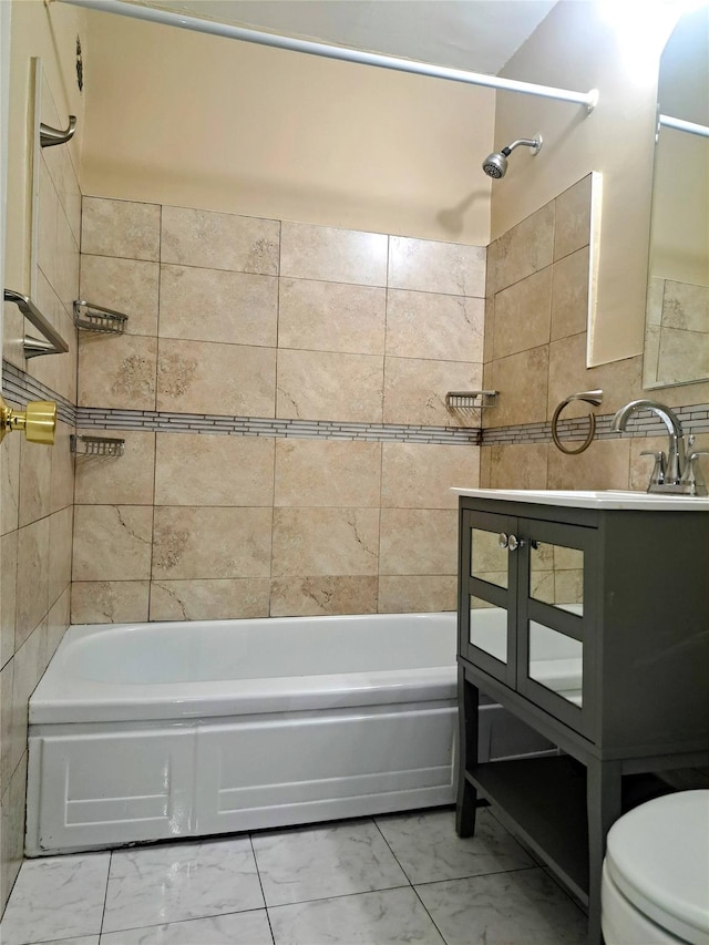 bathroom featuring tiled shower / bath combo and toilet