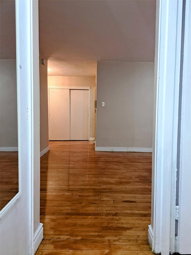 hallway with light hardwood / wood-style floors