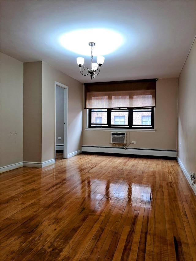 unfurnished living room with baseboard heating, hardwood / wood-style floors, and a chandelier