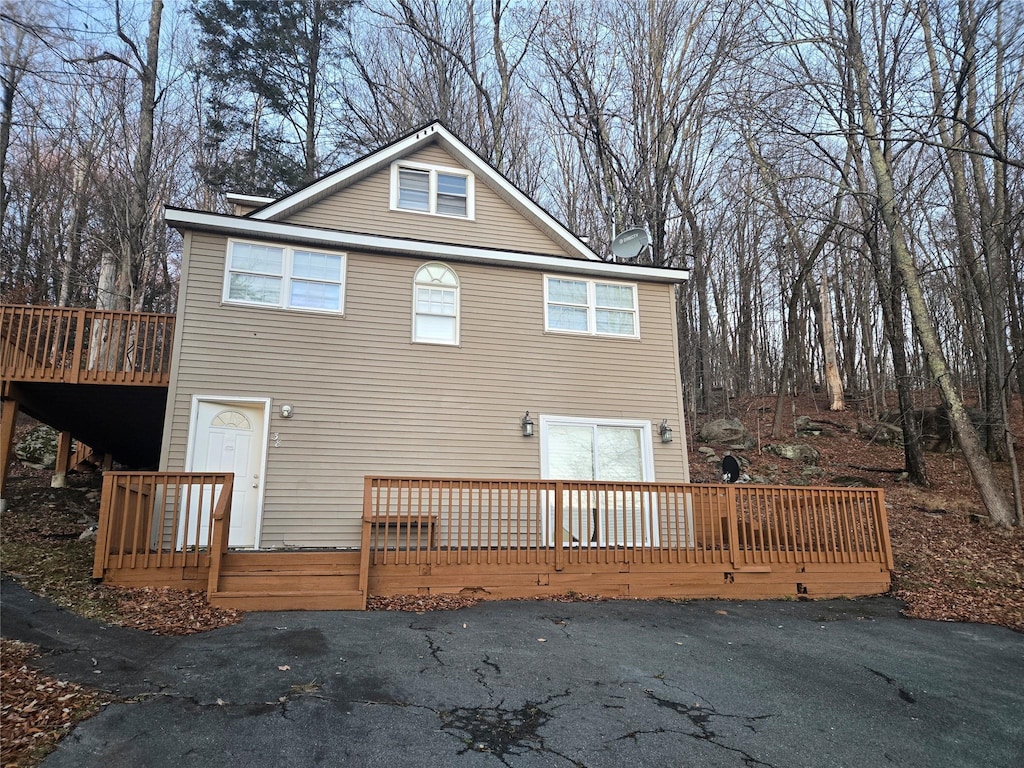 back of property featuring a deck