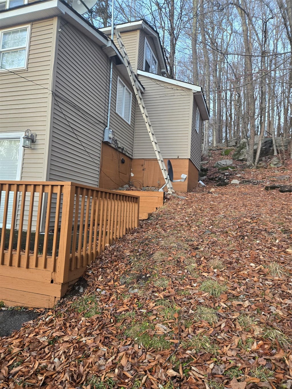 view of property exterior with a wooden deck