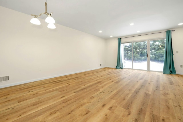 spare room with light hardwood / wood-style floors