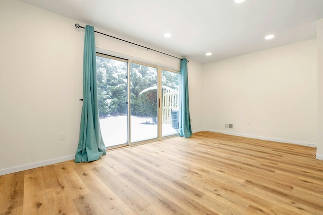 spare room with light hardwood / wood-style floors