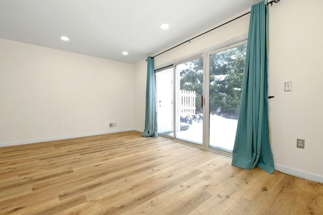 empty room with light hardwood / wood-style flooring