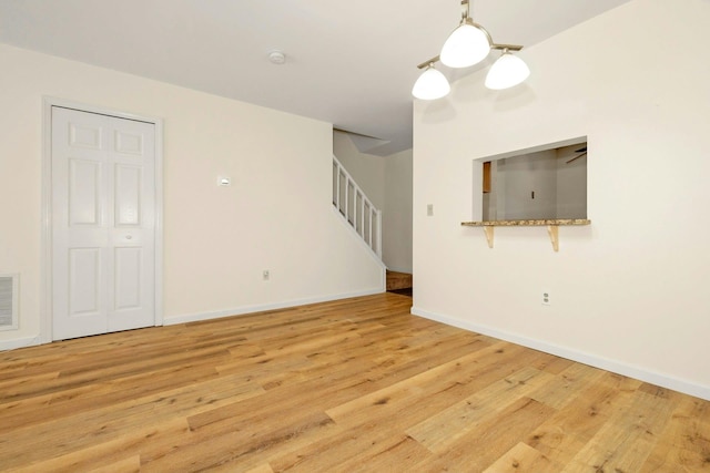 empty room with light hardwood / wood-style flooring