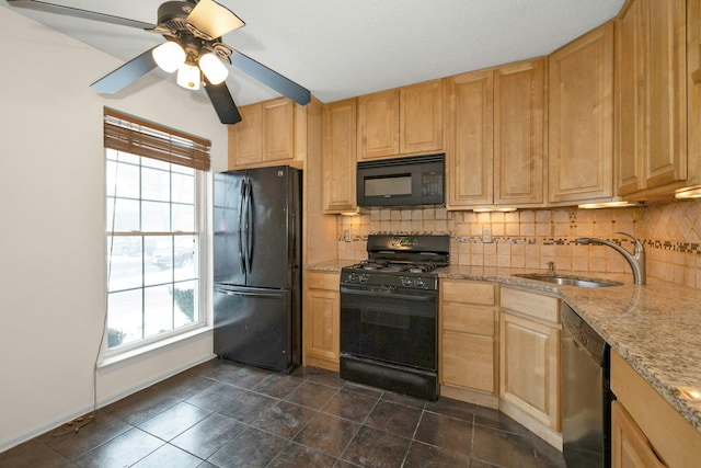 kitchen featuring light brown cabinets, black appliances, sink, ceiling fan, and light stone counters