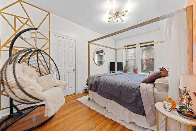 bedroom featuring light hardwood / wood-style floors and a chandelier