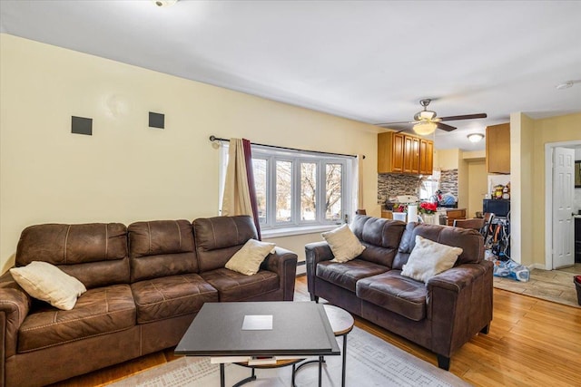 living room with light hardwood / wood-style flooring and ceiling fan