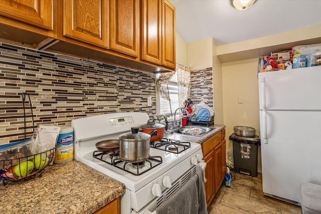 135-07 223rd St, Laurelton, NY 11413 - kitchen featuring white appliances, brown cabinetry, decorative backsplash, and light countertops