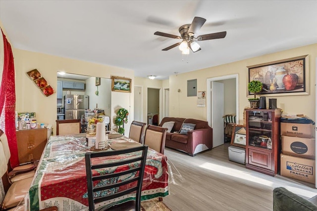 dining space featuring electric panel, ceiling fan, and light hardwood / wood-style flooring