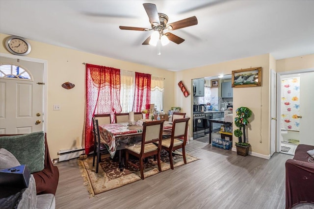 135-07 223rd St, Laurelton, NY 11413 - dining space with a ceiling fan, wood finished floors, and a baseboard heating unit