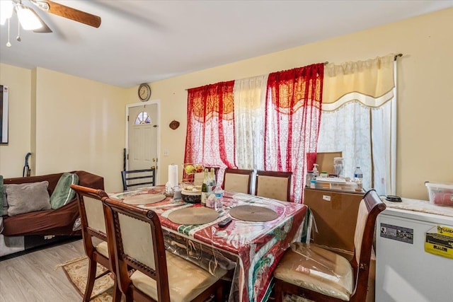 dining area with ceiling fan and light hardwood / wood-style floors