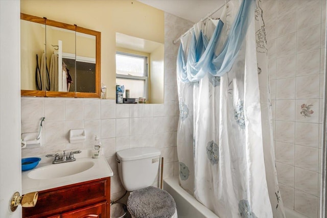 full bathroom with vanity, toilet, decorative backsplash, and tile walls