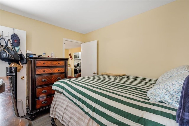 bedroom with dark hardwood / wood-style floors