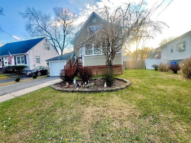 view of front of home with a front yard and a garage