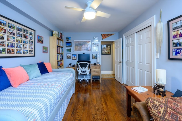 bedroom featuring ceiling fan, a closet, and dark hardwood / wood-style floors