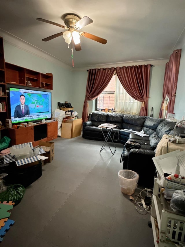 living room featuring ceiling fan and crown molding