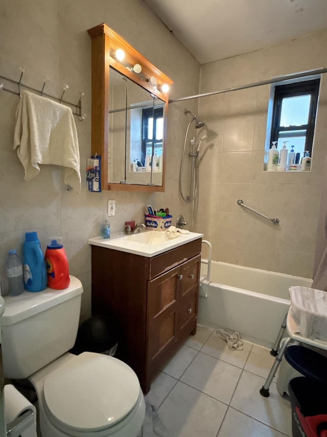 full bathroom with toilet, tile patterned flooring, vanity, and tiled shower / bath