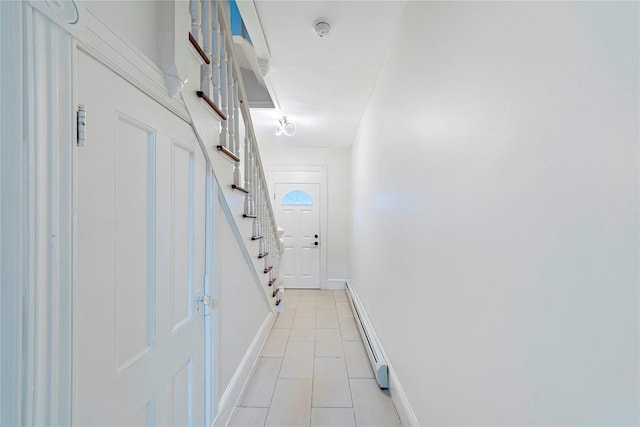 corridor featuring light tile patterned floors and baseboard heating