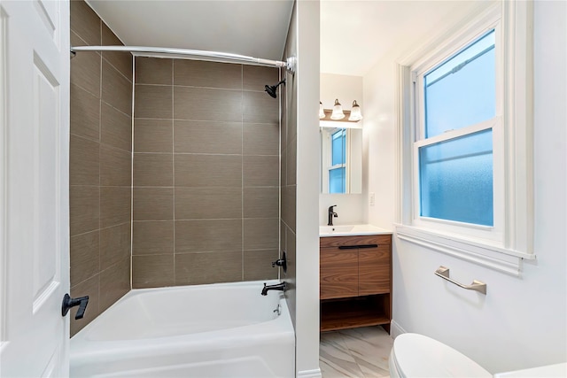 full bathroom with vanity, toilet, and tiled shower / bath combo