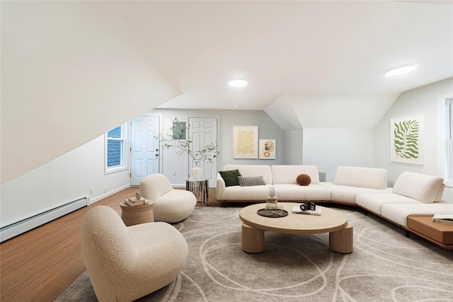 living room featuring carpet, a wealth of natural light, a baseboard radiator, and vaulted ceiling