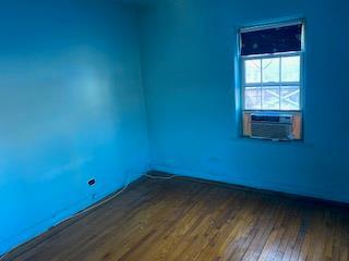 empty room featuring dark hardwood / wood-style floors and cooling unit