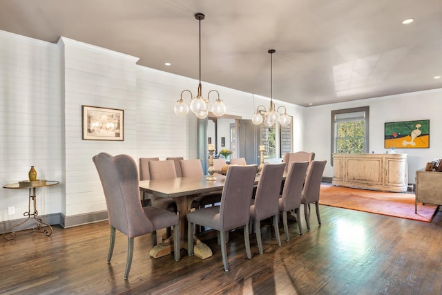 dining area with ornamental molding and dark hardwood / wood-style floors