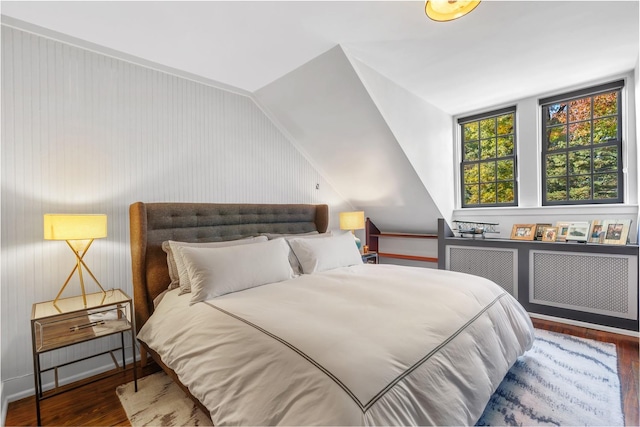 bedroom featuring lofted ceiling and dark wood-type flooring