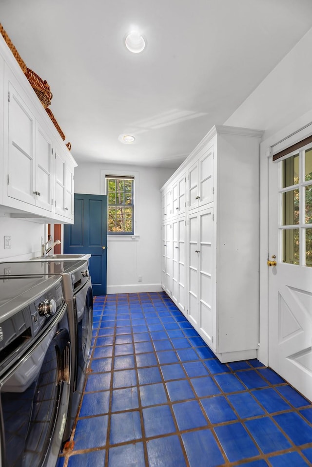 washroom featuring independent washer and dryer and cabinets