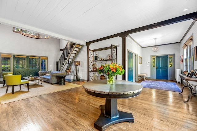 entryway featuring beamed ceiling, radiator, an inviting chandelier, and light hardwood / wood-style floors