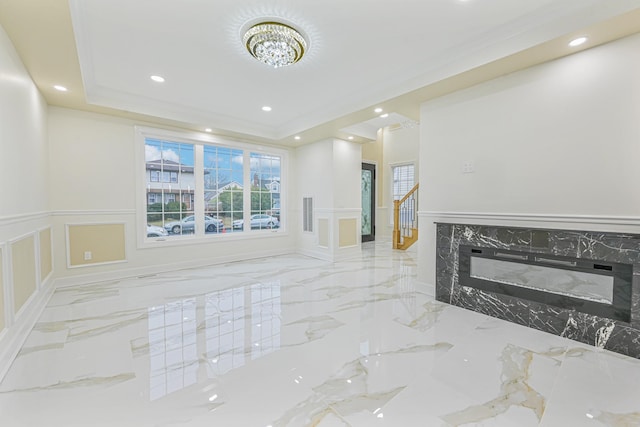 interior space with a raised ceiling and ornamental molding