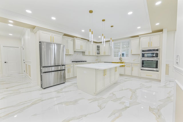 kitchen with stainless steel appliances, a kitchen island, backsplash, pendant lighting, and white cabinets