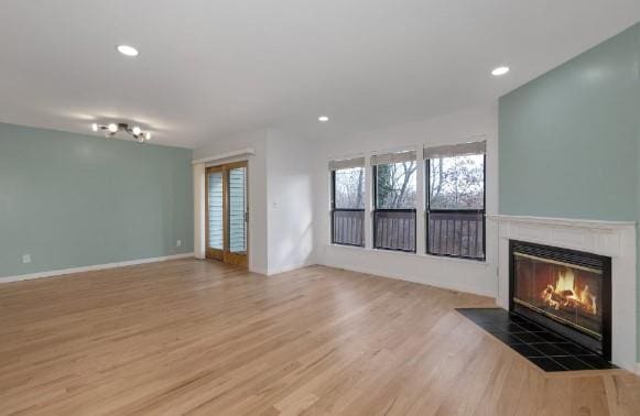 unfurnished living room featuring hardwood / wood-style floors and a fireplace