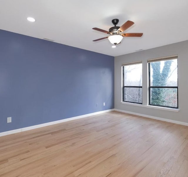 spare room featuring ceiling fan and light wood-type flooring