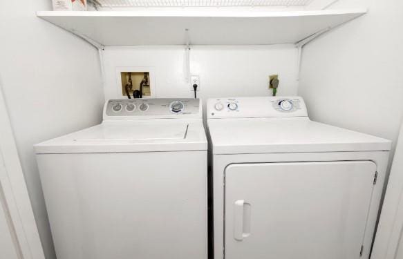 washroom featuring independent washer and dryer