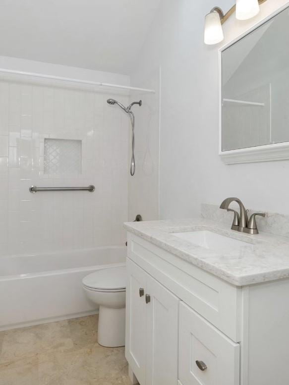 full bathroom with vanity, toilet, and tiled shower / bath