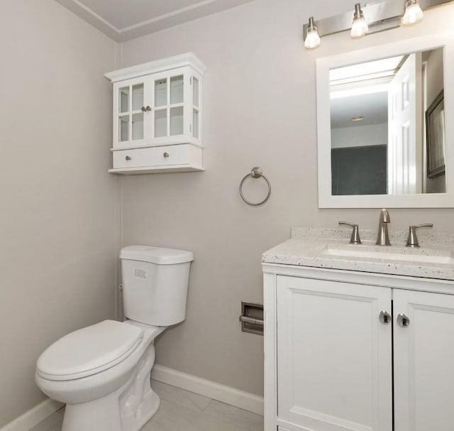 bathroom featuring tile patterned floors, vanity, and toilet